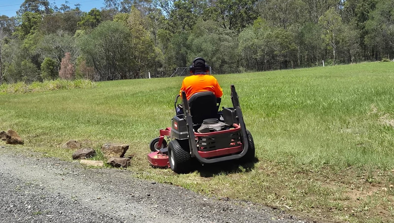 Ride-on mower working on a large lawn